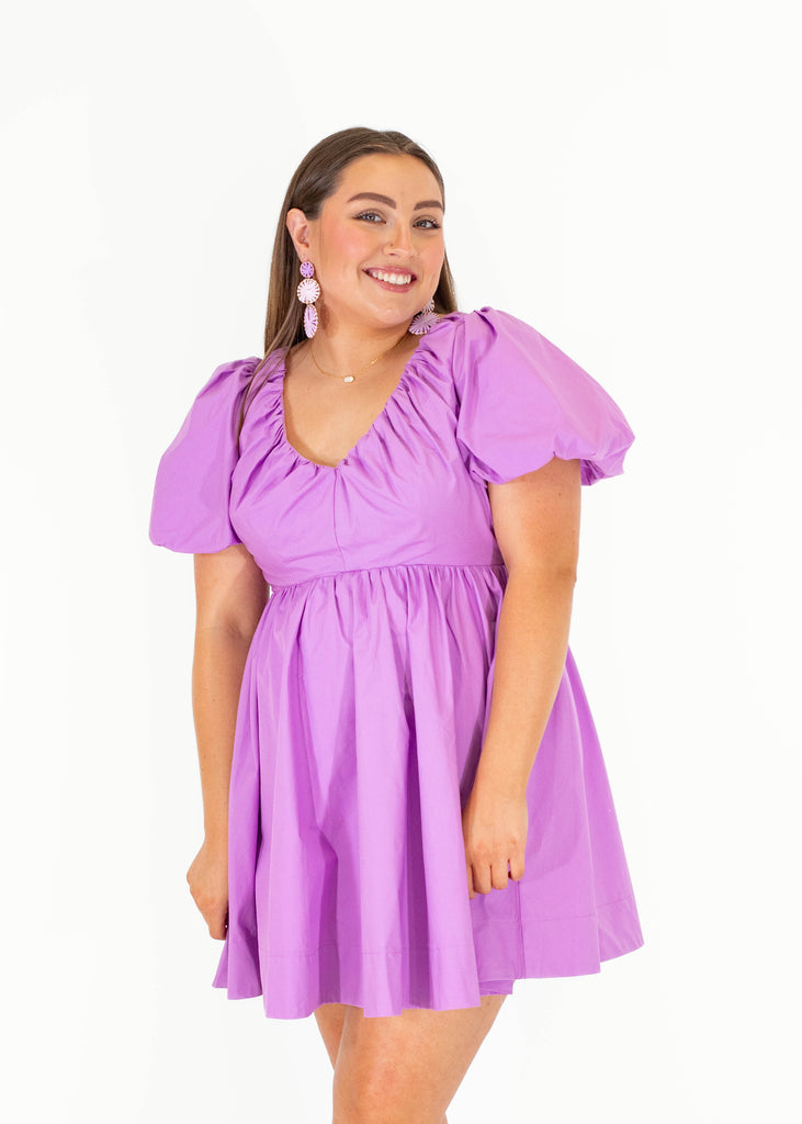 purple dress with puff sleeves and open back