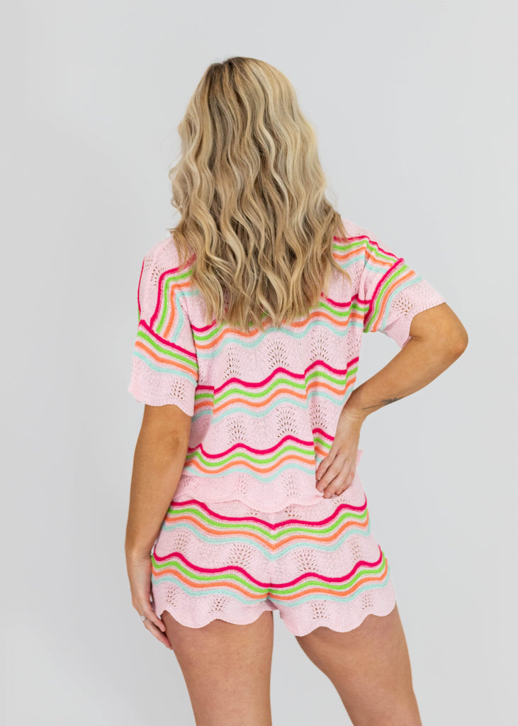 pink knit short sleeve shirt with multi-color stripes