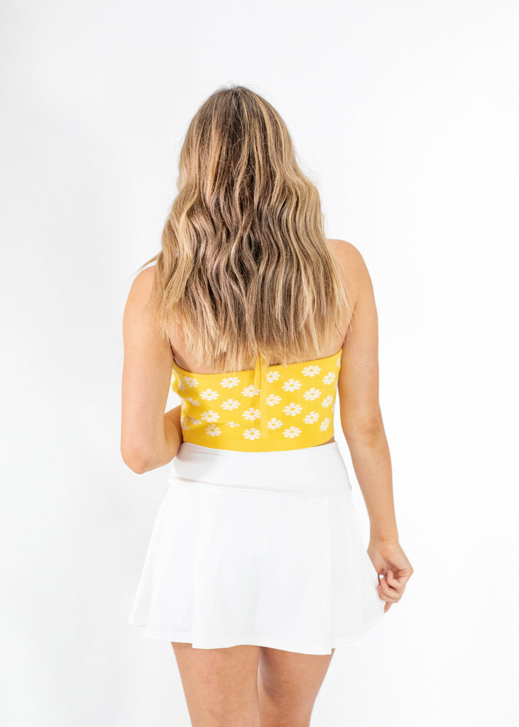 yellow cropped halter top with white flowers