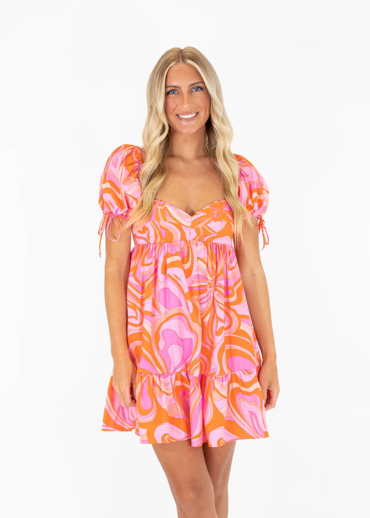 pink and orange printed dress with puff sleeves