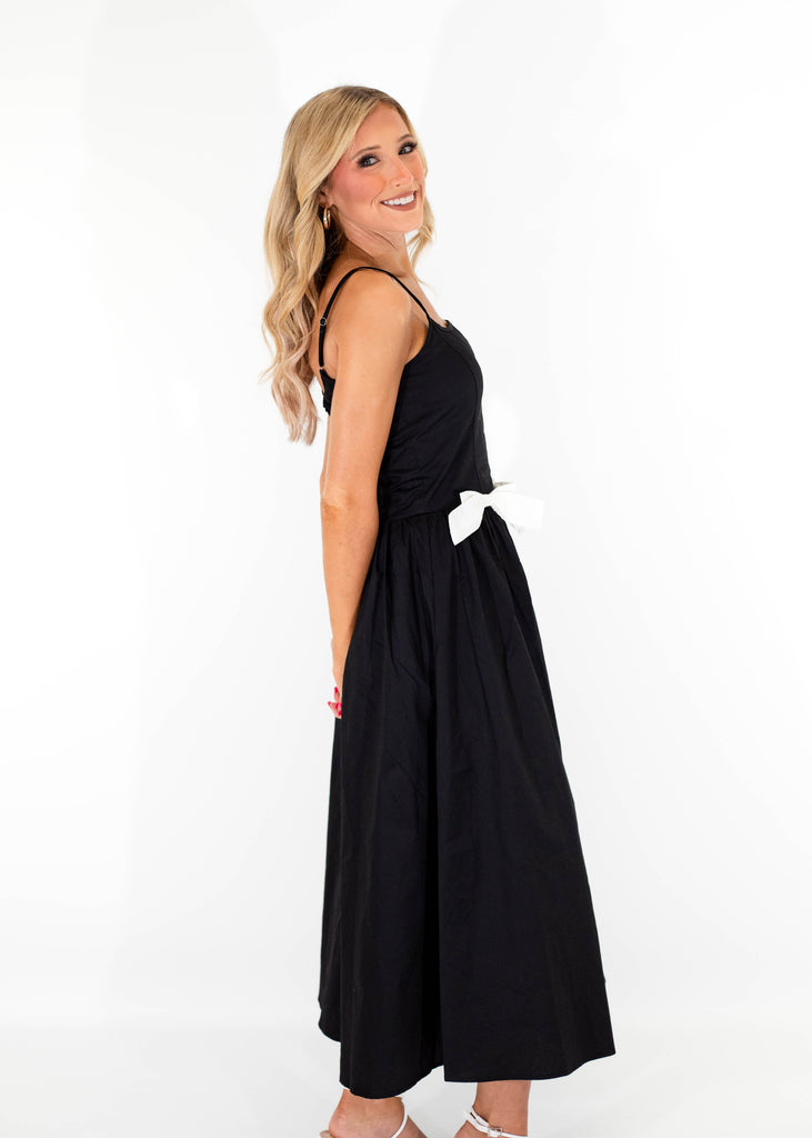 black midi dress with white bow details on front