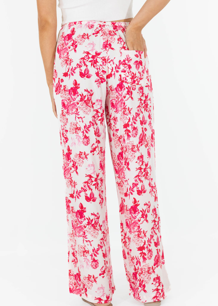 white flowy pants with pink floral pattern