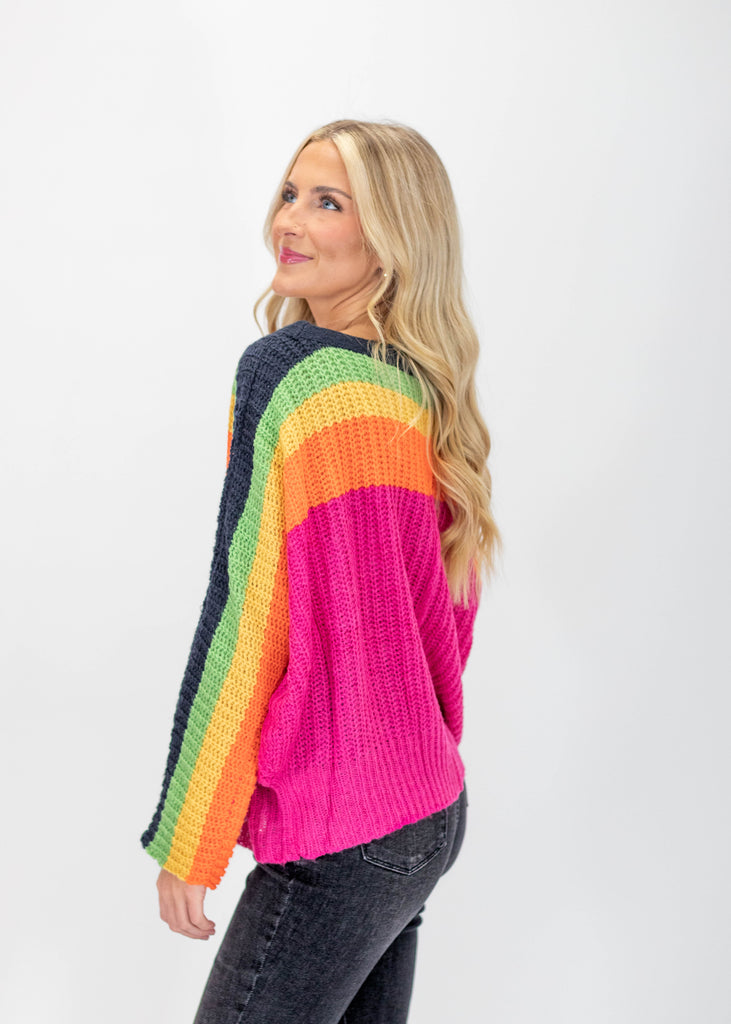 hot pink knit sweater with navy/green/yellow/orange stripes