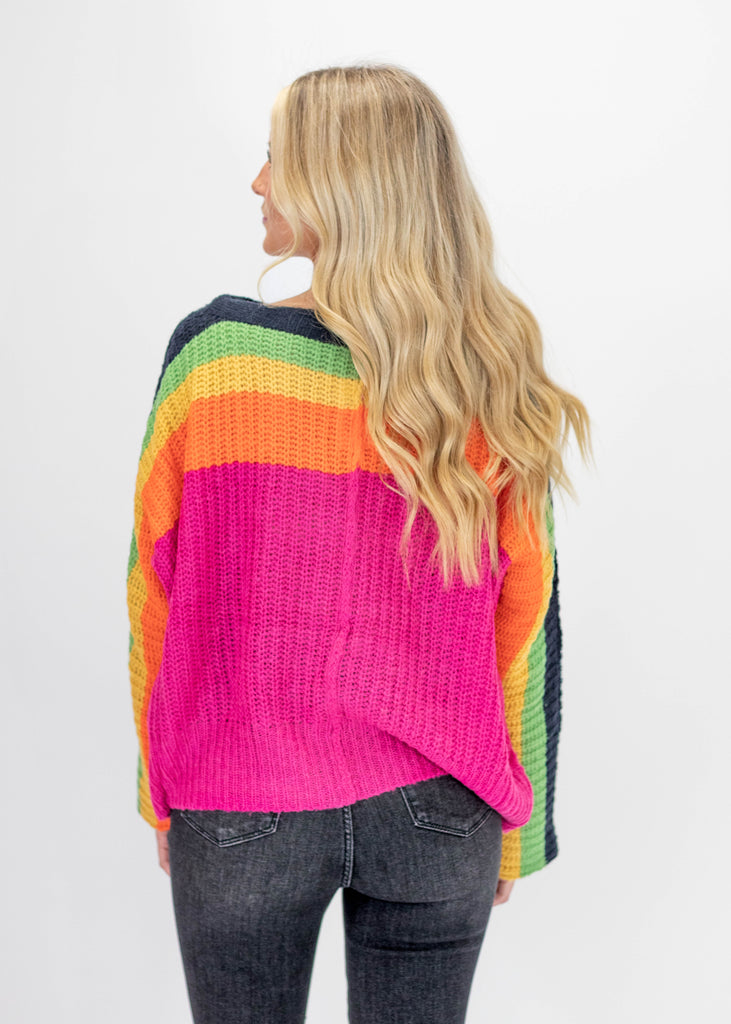 hot pink knit sweater with navy/green/yellow/orange stripes